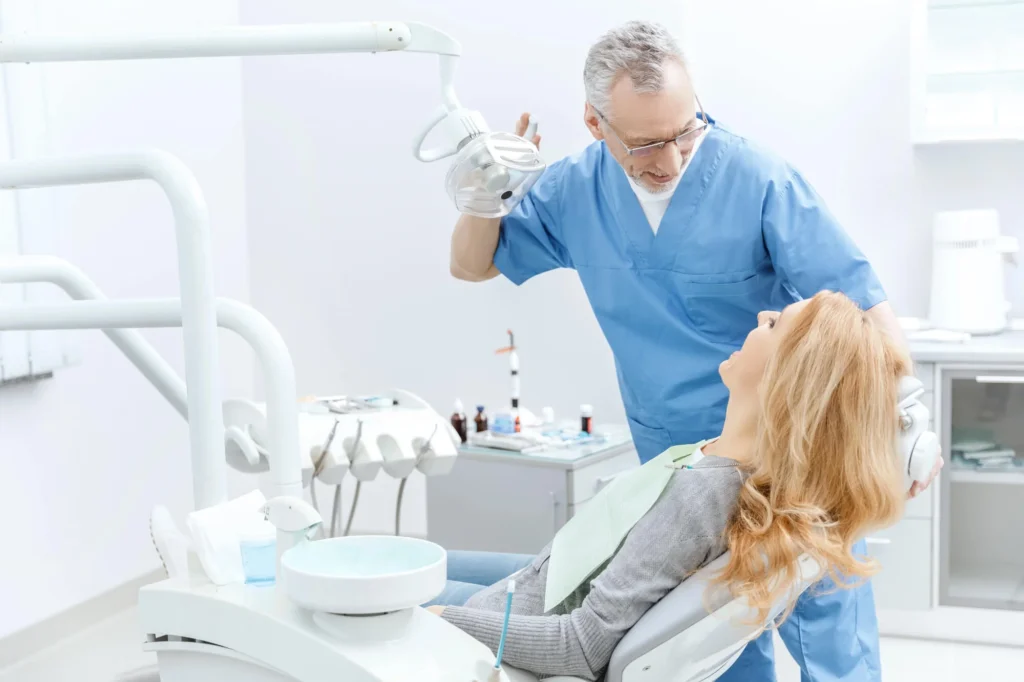Painless dentist in New York City consulting with patient at a trusted dental office.