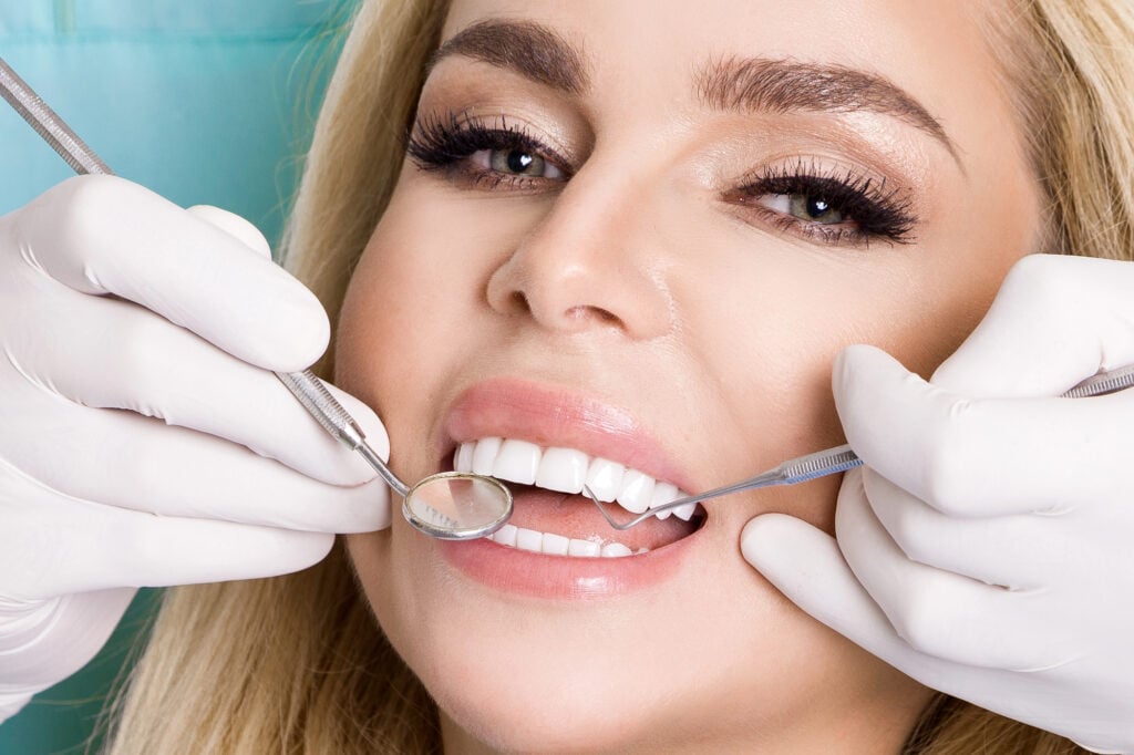 Patient smiling during a visit to a pain free dentistry in New York City.